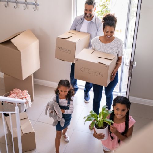 Sell a Property Button - Stock Image of Family of Four Moving Boxes in home - Amy Kristt Lic. Real Estate Salesperson at Warren Real Estate